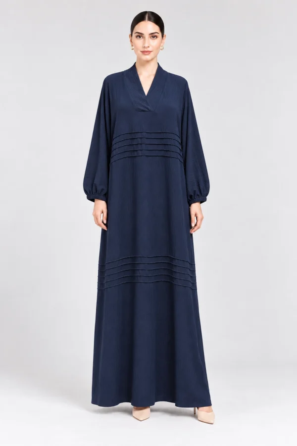 Navy blue closed abaya dress for women with crossover V-neckline, horizontal pintuck detailing and balloon sleeves, front view